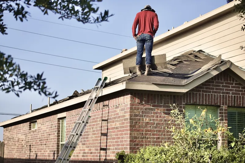 Professional roofer working on a residential roof in Anthem